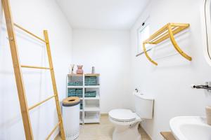 a bathroom with a toilet and a sink at Cozy Haven Santana - Nature & Hiking Trails in Santana +91 photos