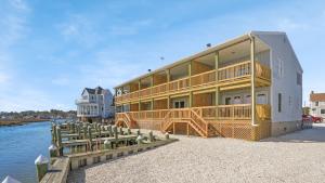 a large building on the water with a dock at Channel Winds - Waterfront Bliss & Lighthouse Views! in Birch Town
