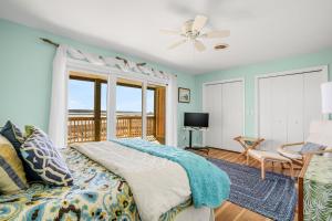 a bedroom with a bed and a balcony at Channel Winds - Waterfront Bliss & Lighthouse Views! in Birch Town