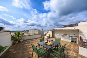 a patio with a table and chairs on a roof at B&B Palazzo Boccaccio in Matino