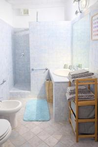 a bathroom with a toilet and a sink and a shower at Casa di Cocco in Alzano Lombardo +10 photos