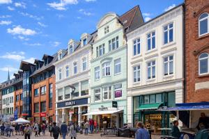 a group of buildings on a street with people walking at fewo1846 - Artemis - vintage Altbau-Wohnung im 4 OG eines Geschäftshauses im Stadtzentrum in Flensburg
