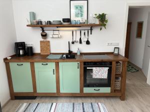 a kitchen with a counter and a sink at Ferienwohnung am Kienbach in Herrsching am Ammersee +5 photos