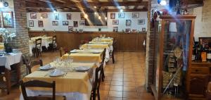a row of tables in a restaurant with yellow table cloth at ThE MATADOR in Mocejón