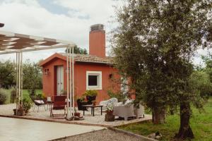 a small house with a brick chimney and a patio at Amatacasa Villa Rosa in Melfi