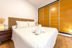 a bedroom with a large bed with white sheets at Collados Experience Piscina y Parking in Águilas +36 photos