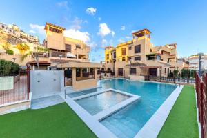 a swimming pool in the middle of a building at Collados Experience Piscina y Parking in Águilas