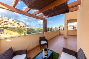 a balcony with a view of a city at Collados Experience Piscina y Parking in Águilas