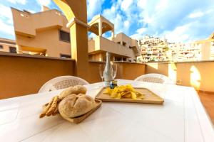 a plate of food on a table with a plate of food at Collados Experience Piscina y Parking in Águilas