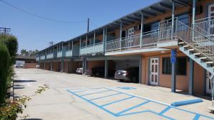 an empty parking lot in front of a building at Espana Motel in Norwalk