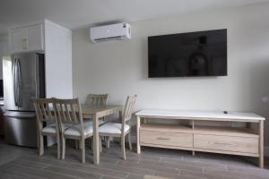 a kitchen with a table and chairs and a refrigerator at The Dex at Coconut Cove in Fort Myers Beach