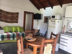a living room with a table and a couch at Complejo Pueblo del Sol in Piriápolis