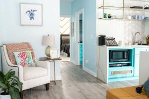 a living room with a chair and a tv at Romantic Guest House · Heated Spa & Pool · Private Retreat in Fort Lauderdale