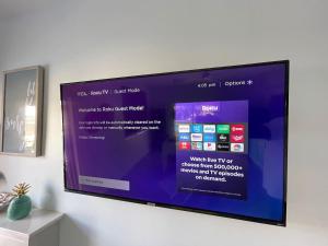 a flat screen tv hanging on a wall at Romantic Guest House · Heated Spa & Pool · Private Retreat in Fort Lauderdale