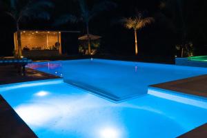 a swimming pool at night with blue lights at Romantic Guest House · Heated Spa & Pool · Private Retreat in Fort Lauderdale +23 photos