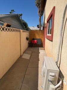 a sidewalk next to a building with a fence at cozy casa colorado in Las Vegas