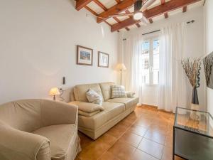 a living room with a couch and a table at Casa Major by 3VILLAS in Fornells