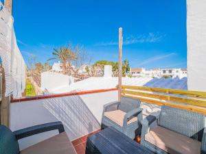 a balcony with two chairs and a hammock at Casa Major by 3VILLAS in Fornells