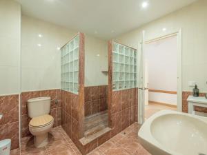 a bathroom with a toilet and a tub and a sink at Casa Major by 3VILLAS in Fornells +18 photos