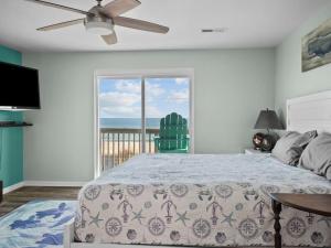 a bedroom with a bed and a view of the ocean at No Work Zone in North Topsail Beach