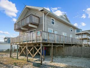 a house on a wooden deck with a fence at No Work Zone in North Topsail Beach