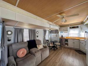 a living room and kitchen of an rv at The Salty Camper in North Topsail Beach
