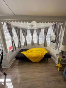 a bedroom with a bed with a yellow blanket at The Salty Camper in North Topsail Beach +30 photos