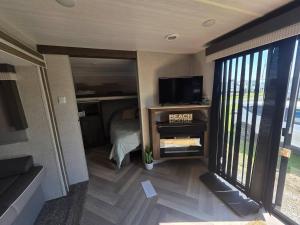 a small bedroom with a bed and a tv in it at Catchin Rays in North Topsail Beach