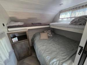 a small room with a bed and a bunk at Catchin Rays in North Topsail Beach +10 photos