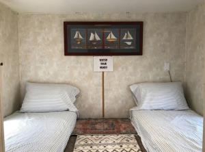 two beds sitting next to each other in a room at Cozy Camper NTB in North Topsail Beach +6 photos