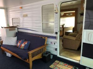 a couch in the back of an rv at Cozy Camper NTB in North Topsail Beach