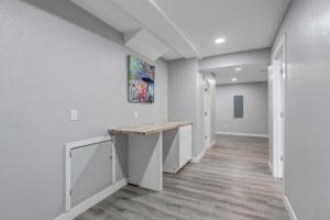 a hallway with white walls and a wooden counter at Denver Retreat in Arvada +33 photos
