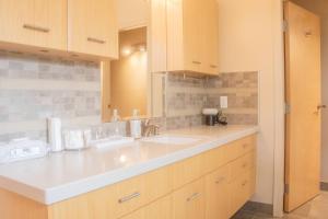 a kitchen with two sinks and a mirror at Quiet Private Room with Ensuite Free Parking in Victoria
