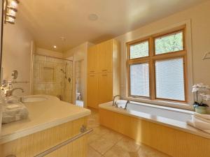 a large bathroom with a tub and a window at Quiet Private Room with Ensuite Free Parking in Victoria