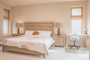 a bedroom with a bed and a chair and two windows at Quiet Private Room with Ensuite Free Parking in Victoria +41 photos