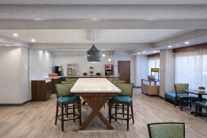 a large kitchen with a table and chairs at Best Western Cy-Fair in Houston