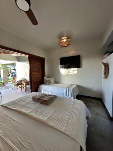 a hotel room with two beds and a tv at Refúgio prea in Cruz