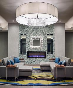 a living room with couches and a fireplace at Waterfront Hotel Downtown Burlington in Burlington