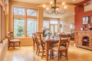 a dining room with a table and chairs and a fireplace at Quiet Private Room with Ensuite - Broadmead 908 in Victoria