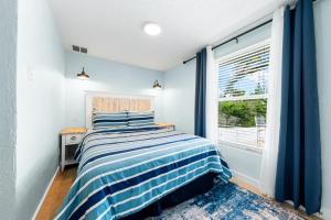 a bedroom with a bed and a window at Star Fish 3 Bed 2 bath POOL Walk to Beach in Sarasota +55 photos