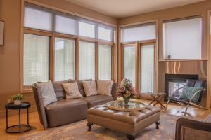 a living room with a couch and a fireplace at Quiet Private Room with Ensuite - Broadmead 908 in Victoria +8 photos