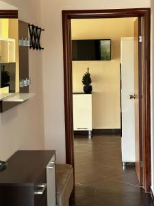 a kitchen with a door and a plant on a counter at Villa 11 Infinity pool & garden in Dobra Voda