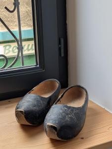 a pair of shoes sitting on a floor next to a window at Chez flader, deux pièces de 55m2 centre historique in Langeac +1 photo