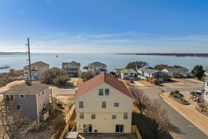 an aerial view of a town with houses and the water at Sounds Like A Plan in Kill Devil Hills