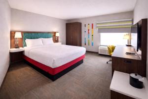 a hotel room with a large bed and a television at Best Western Cy-Fair in Houston +34 photos