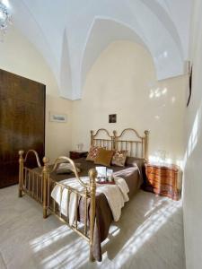 a bedroom with a wooden bed in a room at Mercanti in Manduria