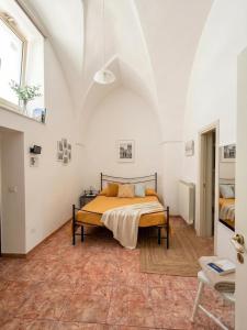 a bedroom with a bed in a white room at Mercanti in Manduria