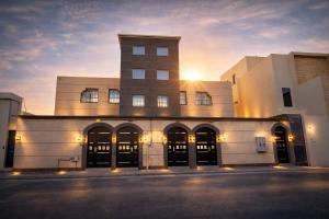 a building with the sun setting in the background at Smo Hail سمو حائل in Hail
