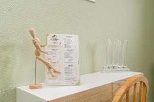 a wooden mannequin sitting on top of a table at Achada do Teixeira Mountain Spot Lodge in Santana