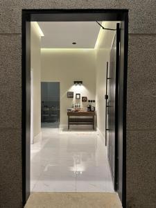 a hallway with a mirror and a table in a room at شقة اند هوم in Hail